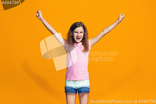 Image of Happy success teen girl celebrating being a winner. Dynamic energetic image of female model