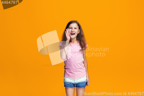 Image of Isolated on yellow young casual teen girl shouting at studio