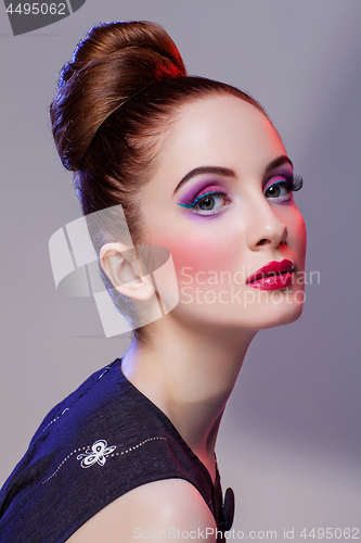 Image of Beautiful girl with hairdo and bright make-up