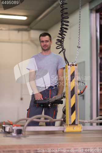 Image of worker in a factory of wooden furniture