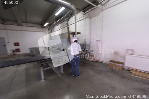 Image of workers in a factory of wooden furniture