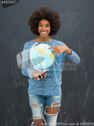 Image of black woman holding Globe of the world