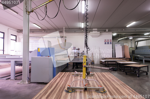 Image of worker in a factory of wooden furniture