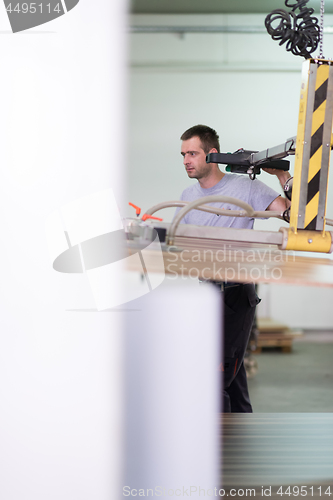 Image of worker in a factory of wooden furniture