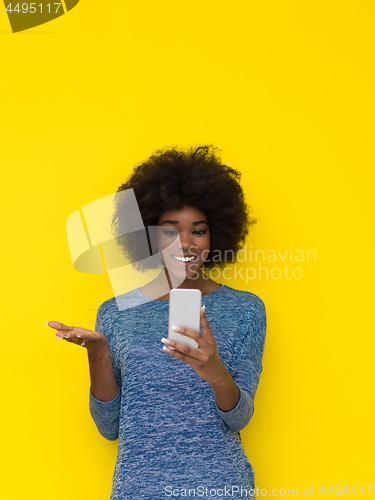 Image of young black Woman Using mobile phone