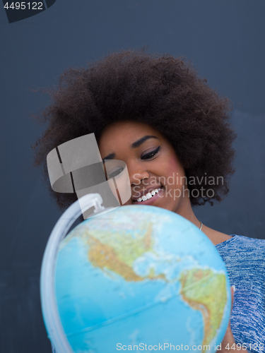Image of black woman holding Globe of the world