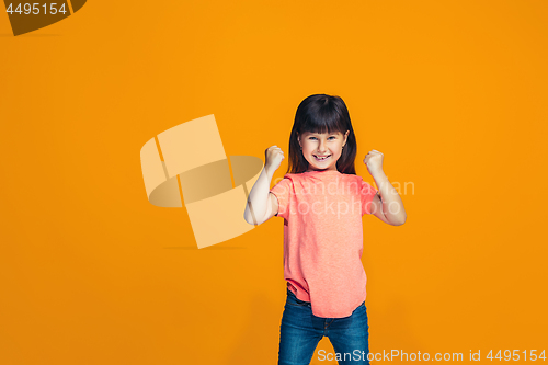 Image of Happy success teen girl celebrating being a winner. Dynamic energetic image of female model