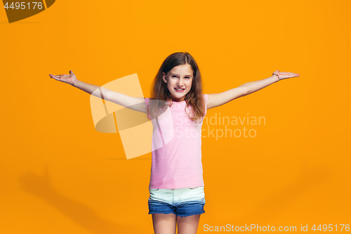 Image of Happy success teen girl celebrating being a winner. Dynamic energetic image of female model