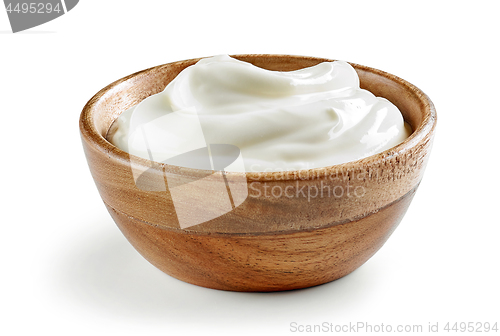 Image of sour cream or yogurt in wooden bowl