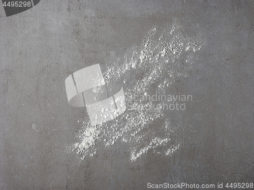 Image of white flour on grey kitchen table