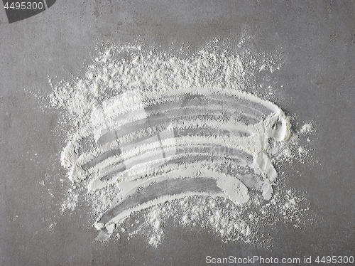 Image of white flour on grey kitchen table