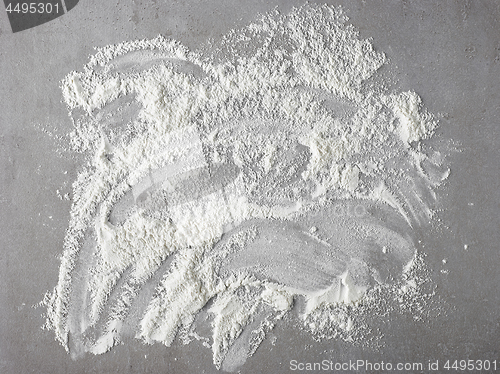 Image of white flour on grey kitchen table