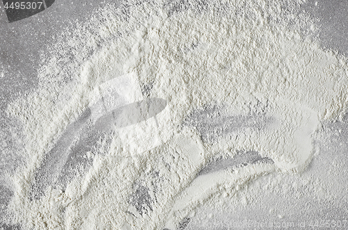 Image of white flour on grey kitchen table