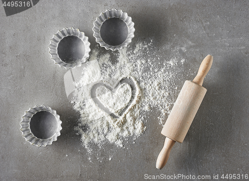 Image of heart shape in flour and baking equipment 