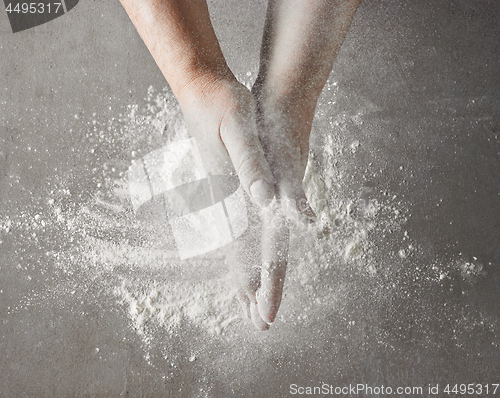 Image of baker hands with flour in motion