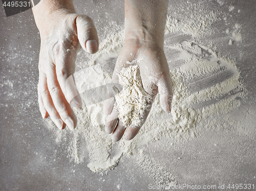 Image of baker hands with flour in motion