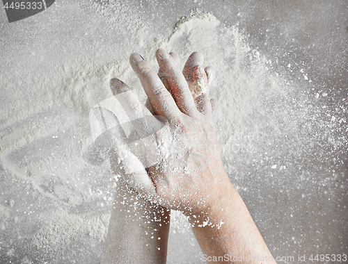 Image of baker hands with flour in motion