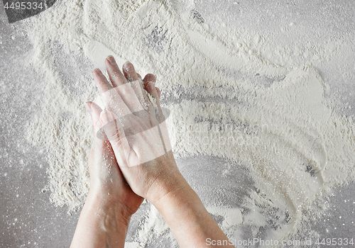 Image of baker hands with flour in motion