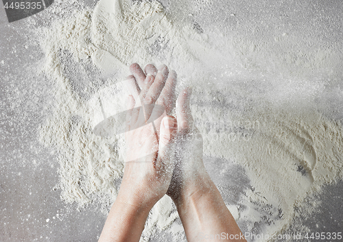 Image of baker hands with flour in motion