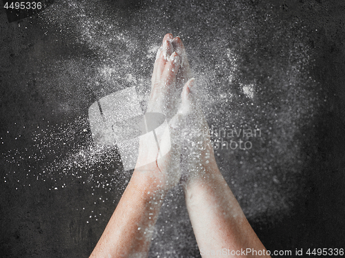 Image of baker hands with flour in motion