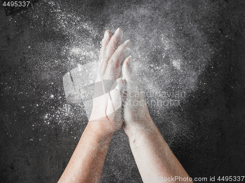 Image of baker hands with flour in motion