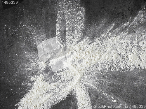 Image of white flour on black kitchen table