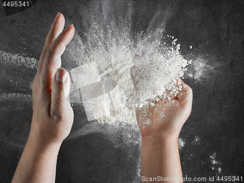 Image of baker hands with flour in motion