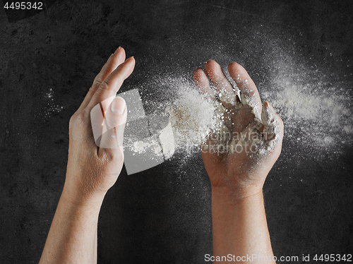 Image of baker hands with flour in motion