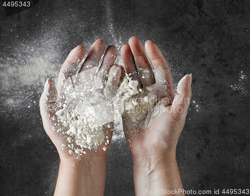 Image of baker hands with flour in motion