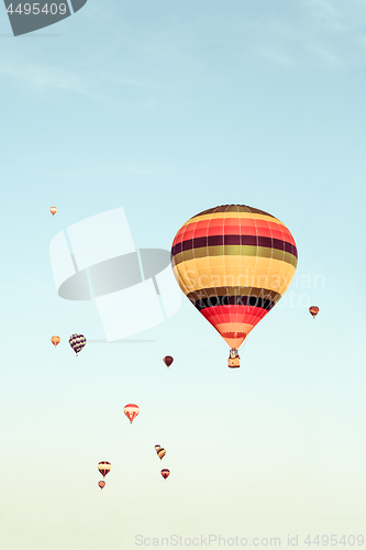 Image of Colorful hot air balloons flying in the distance