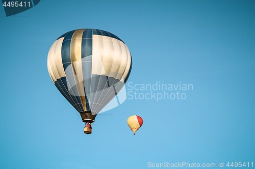 Image of Two hot air balloons in the clear sky