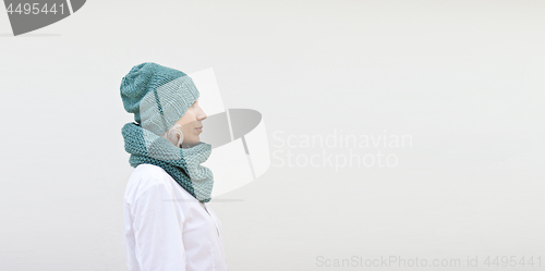 Image of Pretty woman in warm turquoise knitted hat