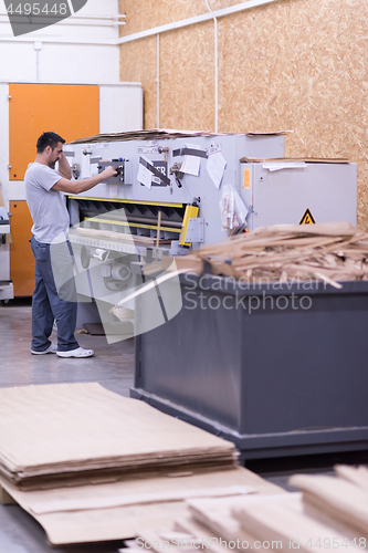 Image of worker in a factory of wooden furniture