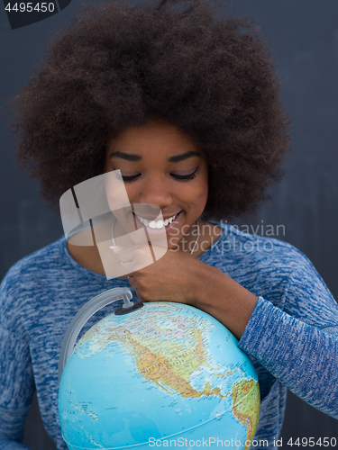 Image of black woman holding Globe of the world