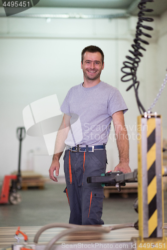 Image of worker in a factory of wooden furniture