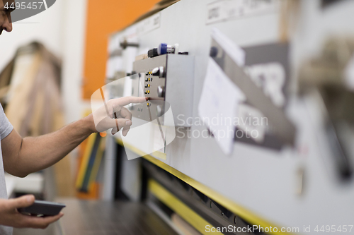 Image of worker in a factory of wooden furniture