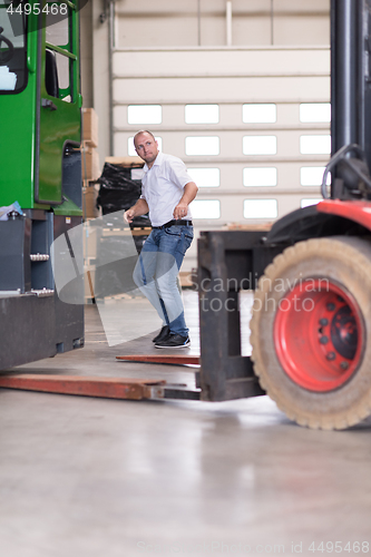 Image of worker in a factory of wooden furniture