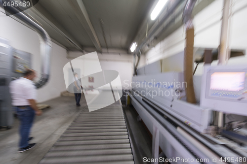 Image of workers in a factory of wooden furniture