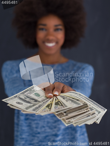 Image of black woman holding money on gray background