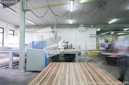 Image of worker in a factory of wooden furniture