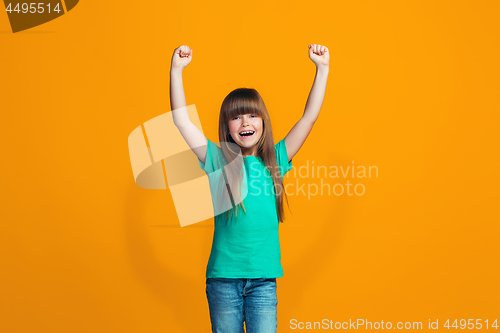 Image of Happy success teen girl celebrating being a winner. Dynamic energetic image of female model