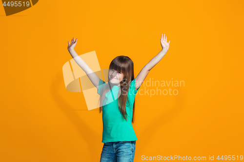 Image of Happy success teen girl celebrating being a winner. Dynamic energetic image of female model