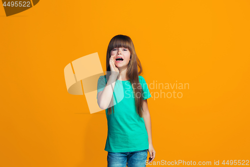 Image of Isolated on yellow young casual teen girl shouting at studio