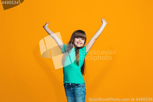 Image of Happy success teen girl celebrating being a winner. Dynamic energetic image of female model