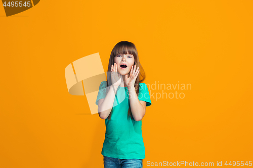 Image of Isolated on yellow young casual teen girl shouting at studio