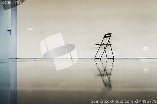 Image of Lonely black chair at the empty dancing hall