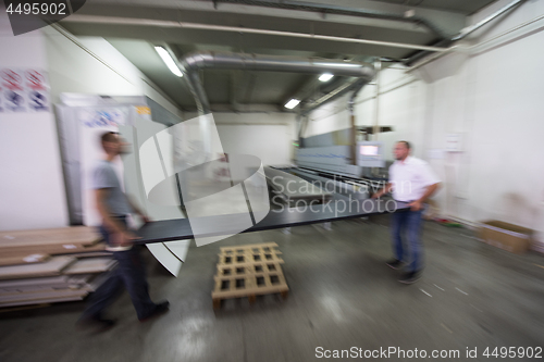 Image of workers in a factory of wooden furniture