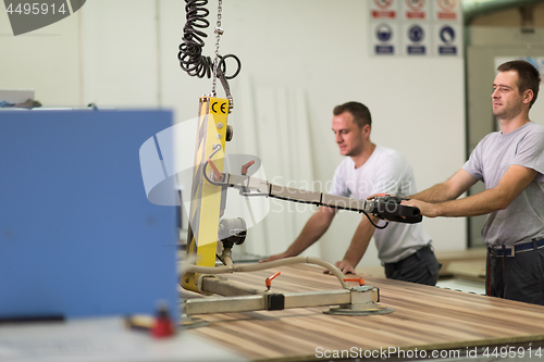 Image of workers in a factory of wooden furniture