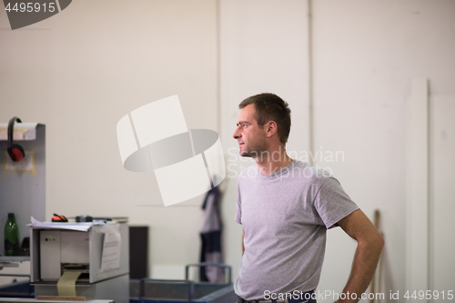 Image of worker in a factory of wooden furniture