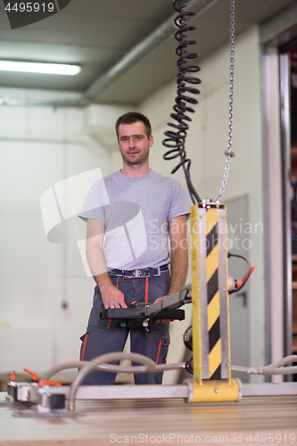 Image of worker in a factory of wooden furniture